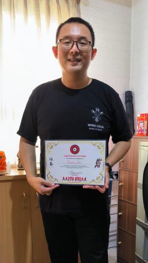 Ivan Lee with certificate from Maurice Novoa